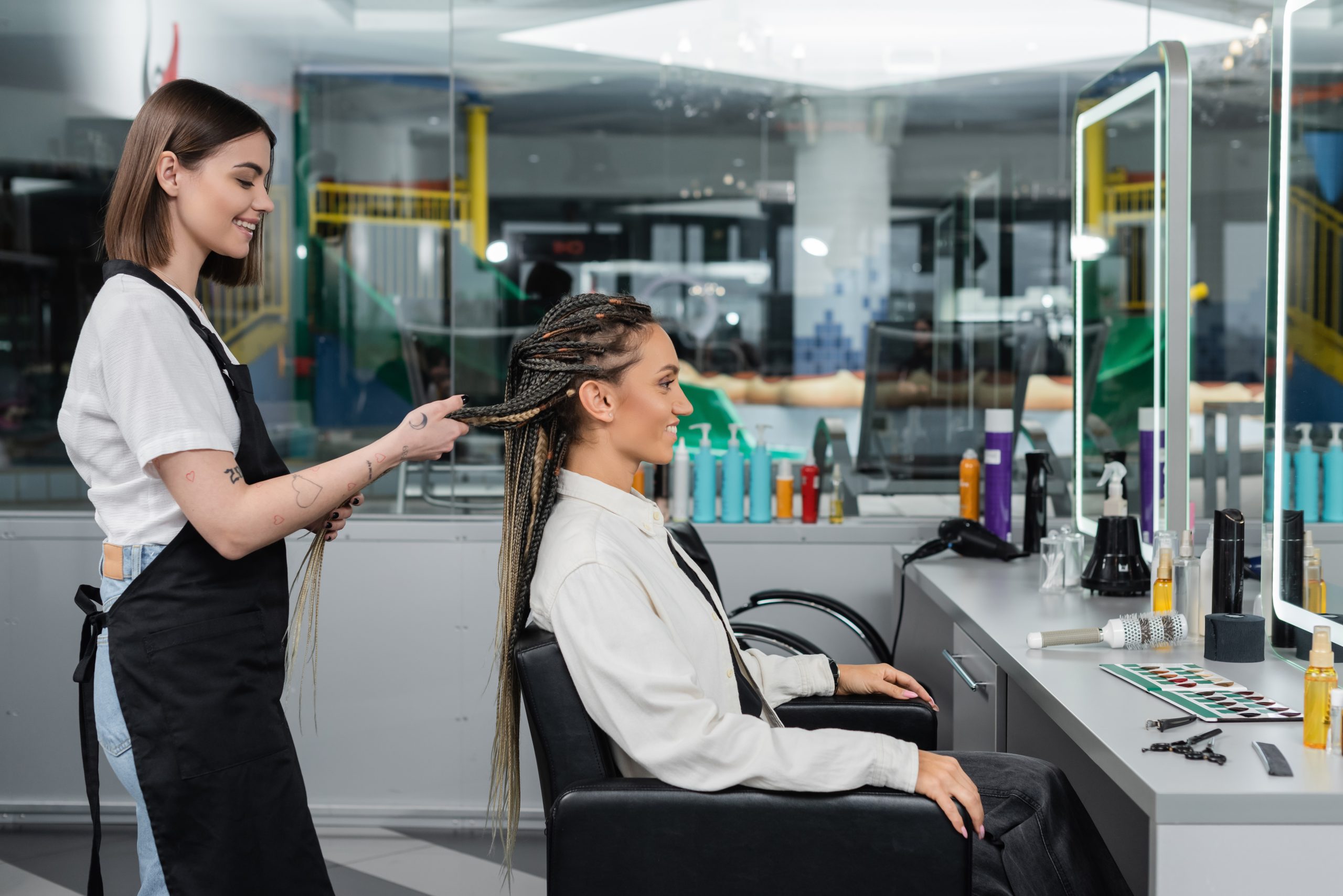 Salon owner treating client's hair with product