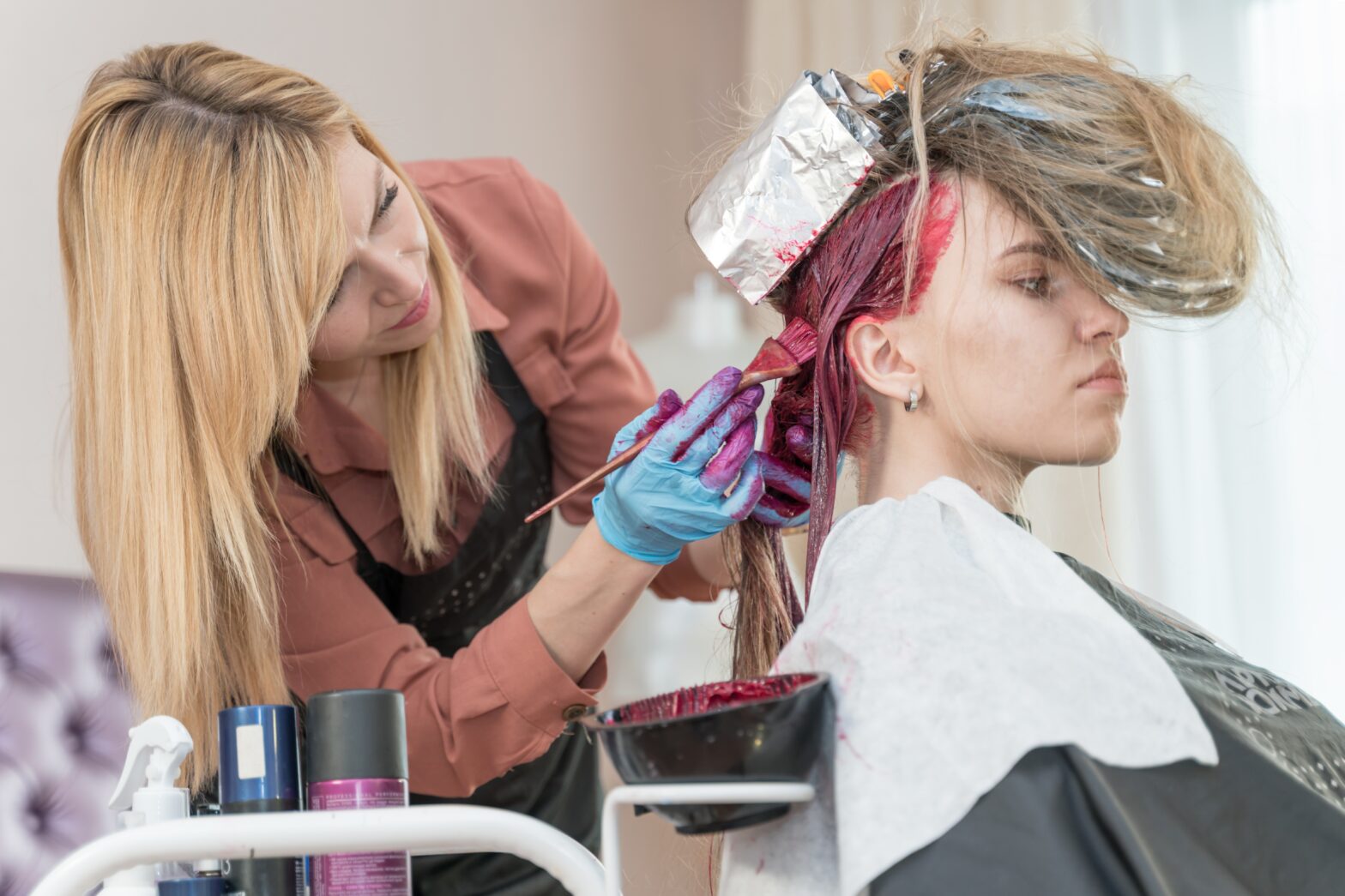 Woman gets her hair coloured by salon expert while sharing tips on how to care for it.